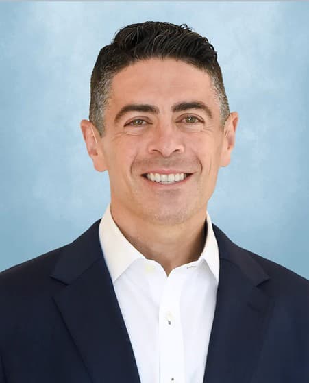 Studio portrait of Dr Bryce Appelbaum wearing a jacket and white shirt