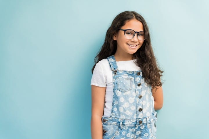 girl wearing denim overalls glasses