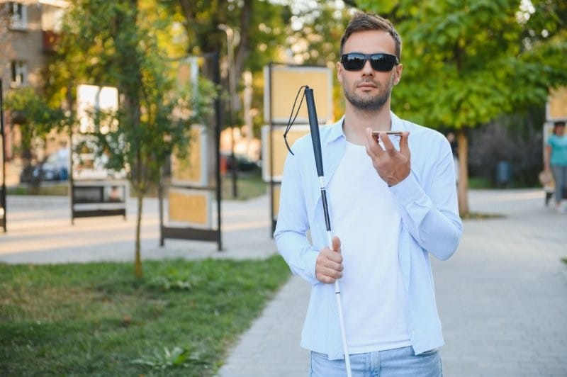 young man with white cane