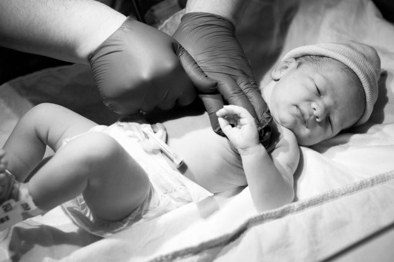 closeup doctor checking newborn