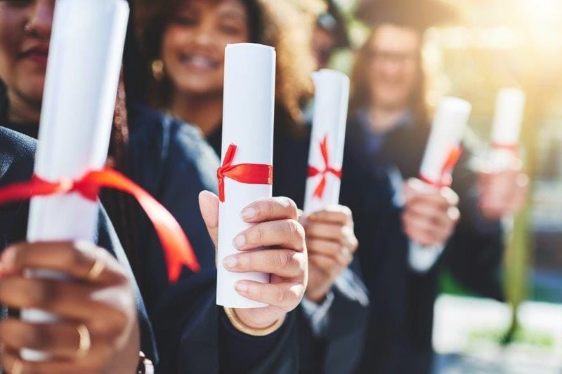 graduation hands students with diploma online