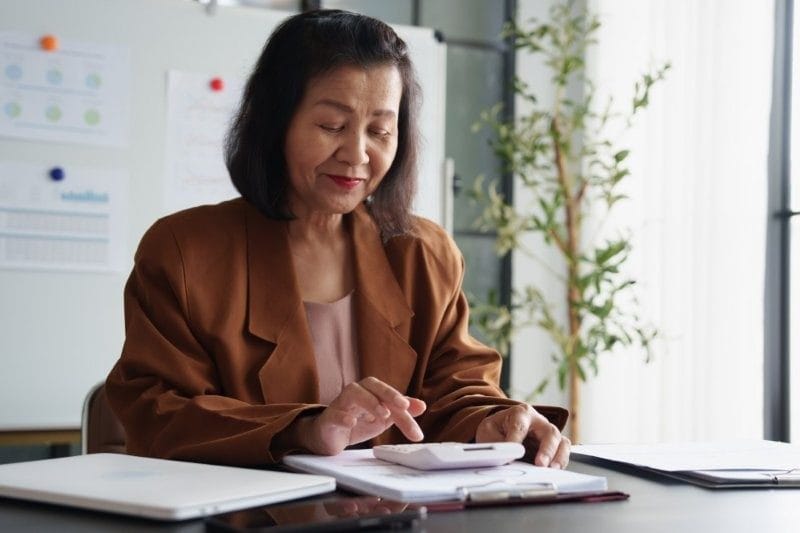 middle age asian woman auditor calculator Online