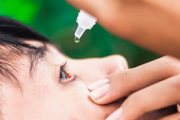 boy dropping eye drop
