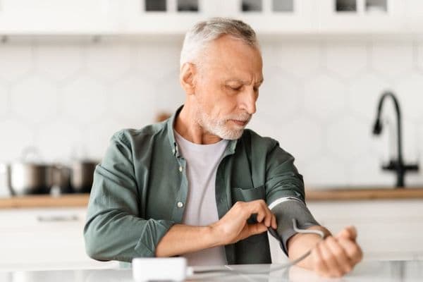 senior man checking blood pressure small