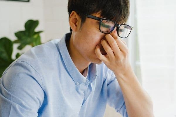 asia businessman using laptop sore eyes small